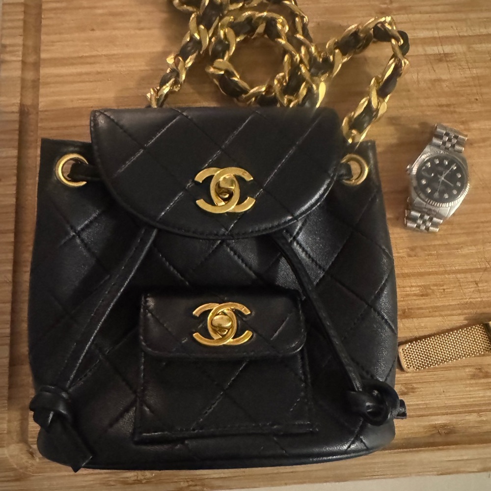 CHANEL Black and Gold Quilted Backpack with Iconic Design